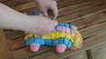 Load and play video in Gallery viewer, Detailed view of the Fiesta Pinata Snuffle Toy's soft, plush texture, crafted from recycled materials, providing a sustainable and enjoyable feeding experience for dogs.
